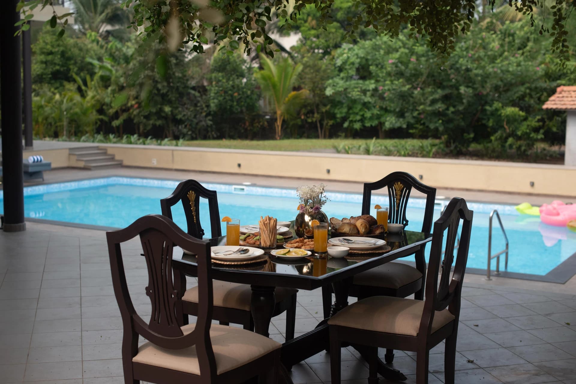 Poolside dining at a Hestia villa, Alibag — a project tracked remotely in HSIOS™